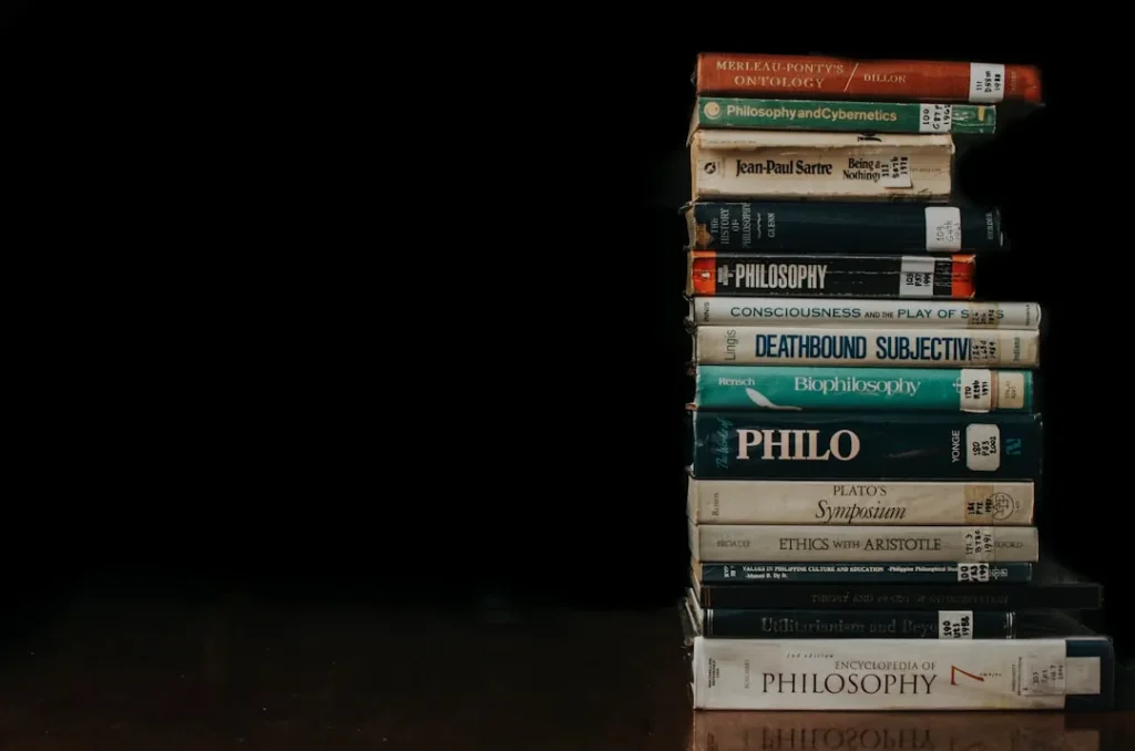 Masonic knowledge and enlightenment texts stacked on wooden surface