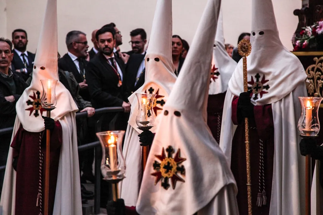Initiates wearing white robes during ceremonial degree advancement ritual