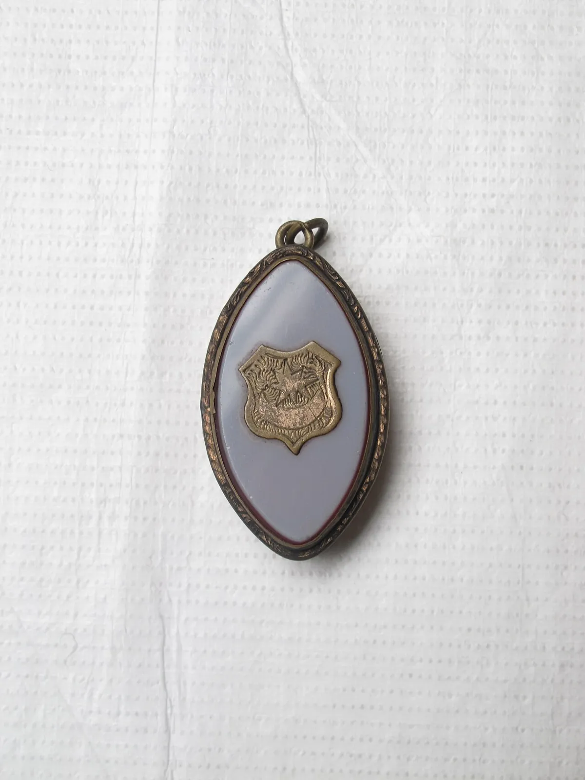 Gold locket engraved with compass, square, and star symbolizes core freemasonry beliefs