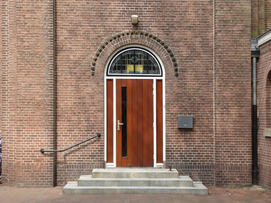Classical doorway framed by archway, mirroring sacred pillar architecture