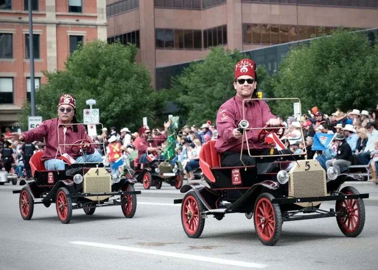 Shriners parade procession featuring classic automobiles and ceremonial participants