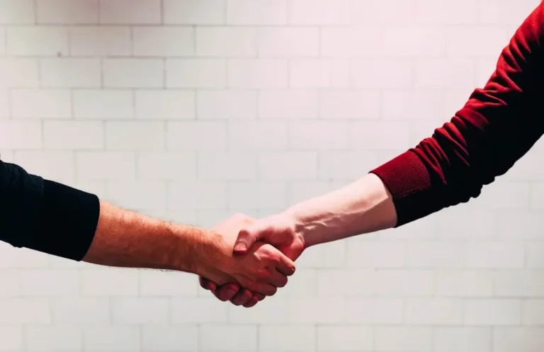 Formal masonic handshake greeting between two professionals indoors