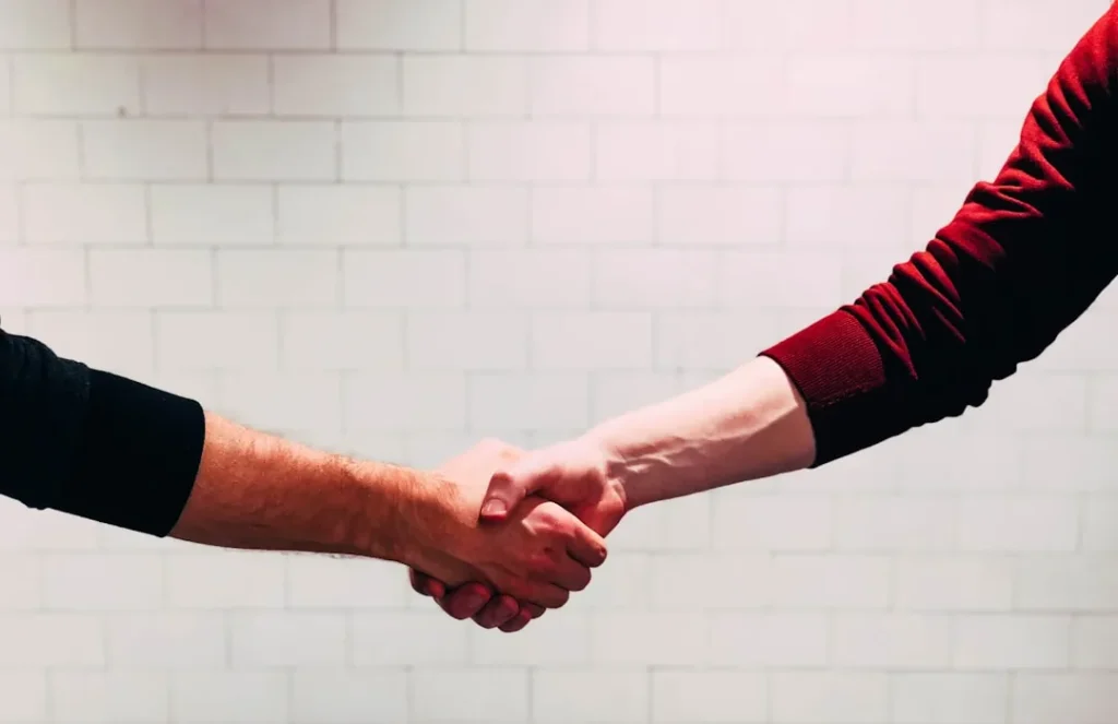 Formal masonic handshake greeting between two professionals indoors